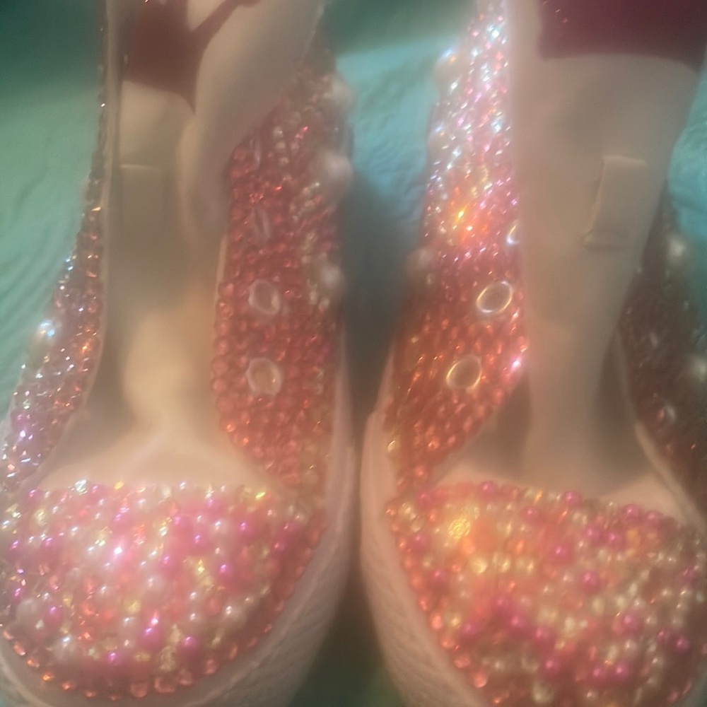 Blinged out tennis shoes with pink and white pearls.